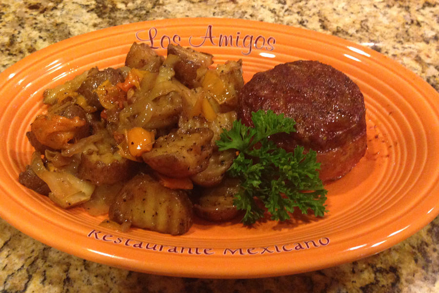 Mini elk meatloaves wrapped in bacon and grilled home fries.