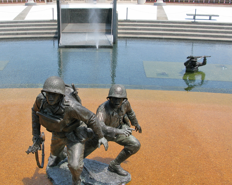 Medic going up the beach with a solider, note the cross on his helmet and lack of a weapon 