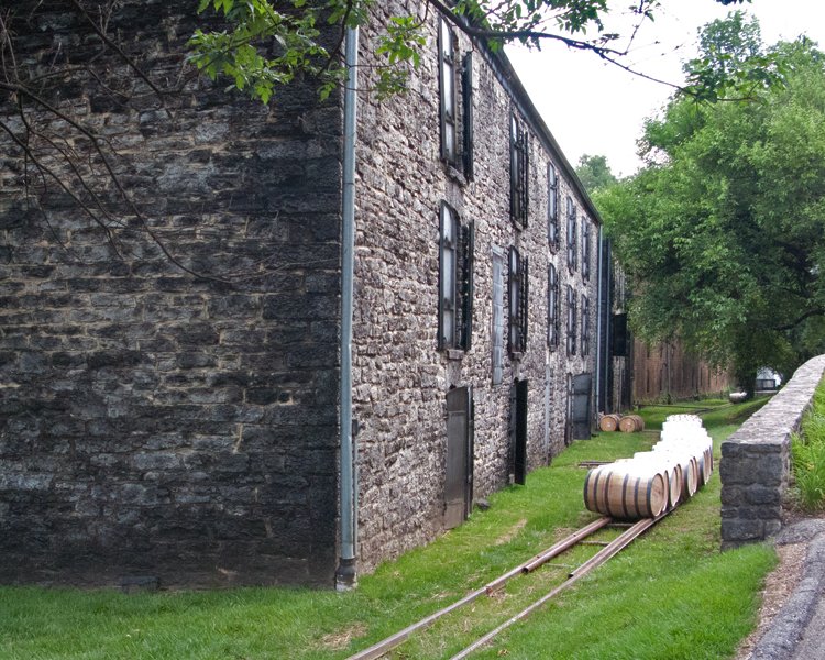Limestone buildings (circa 1878) are part of the distillery here at Woodford's Reserve.  The rails that you see the barrels on runs over 500 feet from where the barrels are filled.  Each barrel weighs over 500 lbs. 